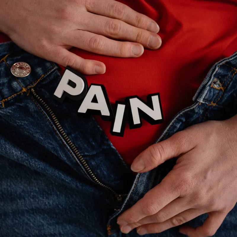 A woman holding her stomach in pain