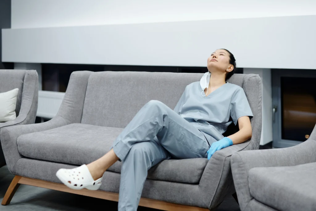 A nurse resting on a sofa in a hospital