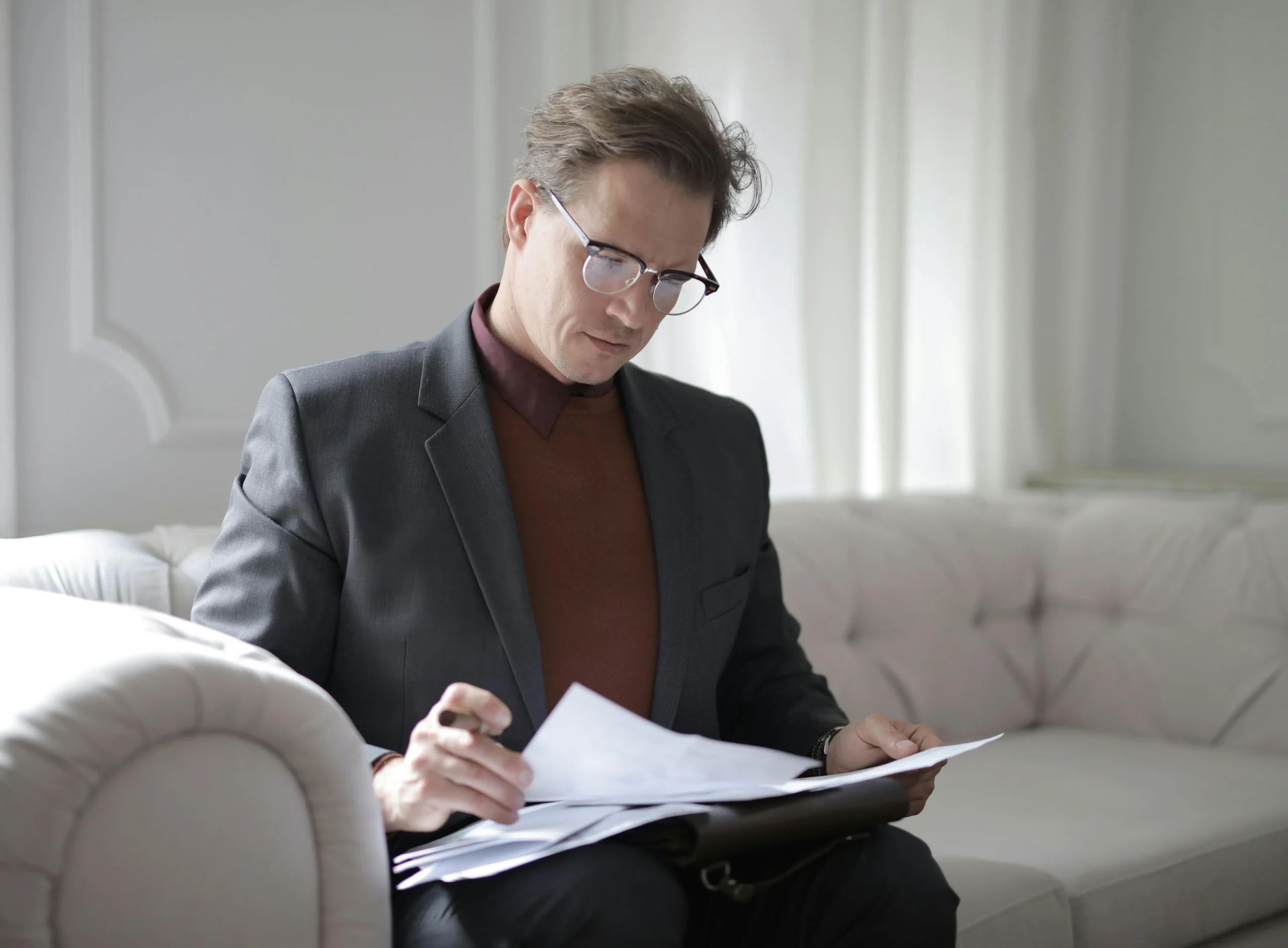 9e6e789e b0fc 44ea 96af 7b535ba757eewebp - Endometriosis Center of Excellence An insurance company representative looking at paperwork