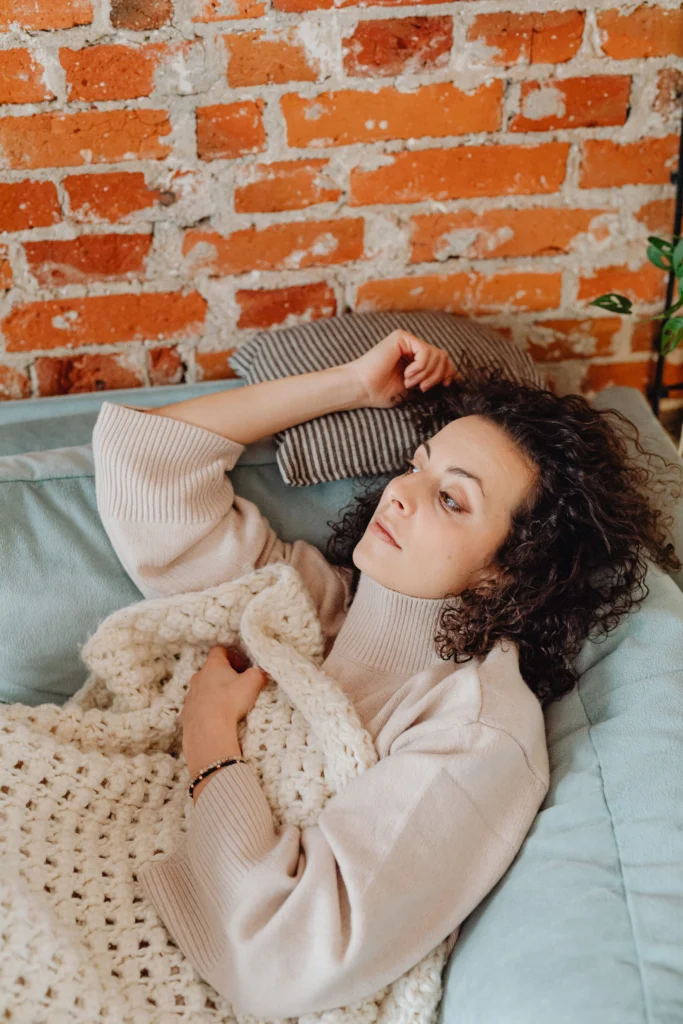 A woman resting in bed in pain