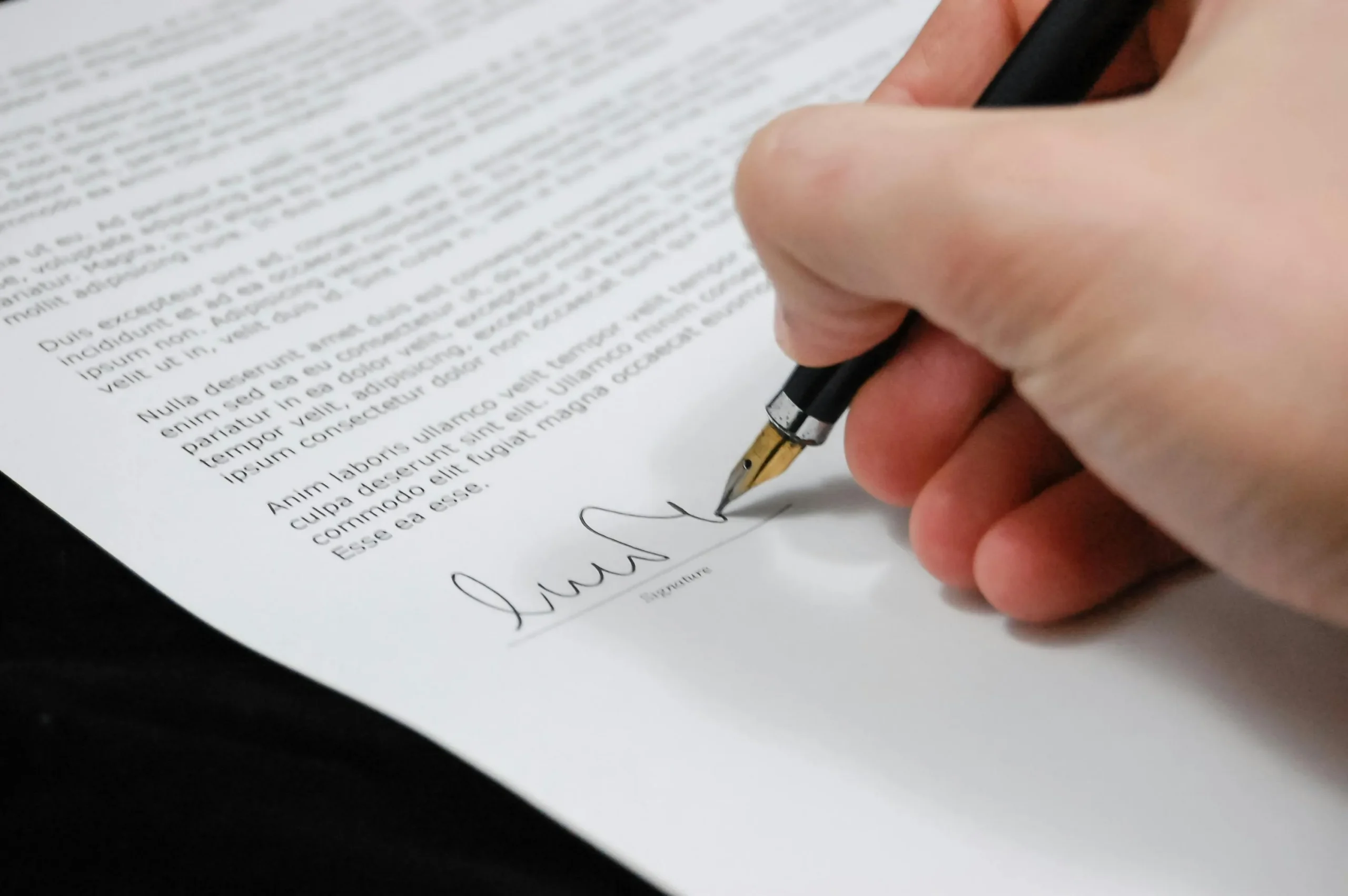 d53f5745 1477 47d2 b311 b86059a8a9f9webp - Endometriosis Center of Excellence A person signing a document
